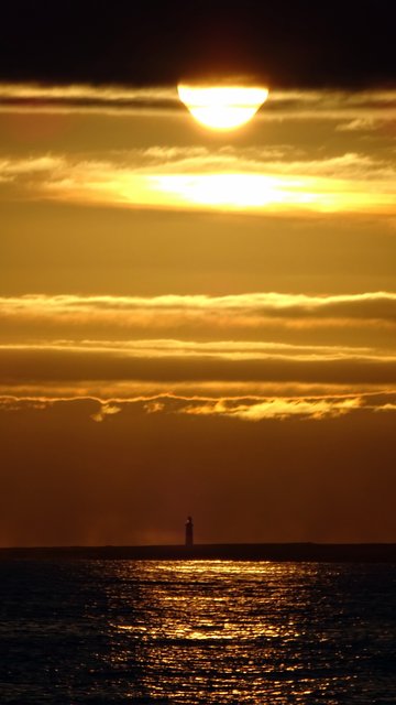 Sonnenuntergang in Dingel be Irland mit Leuchtturm