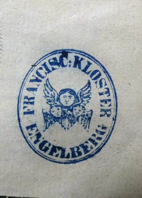 Abdruck eines alten Stempels des Engelberger Klosters mit drei Engelgesichtern.