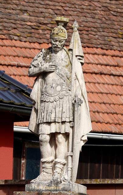  Zwei Kunstwerke verweisen im Eichenbühler Höhen-Ortsteil auf den populären Heiligen: am Ehrenmal im Freien und eine Barockfigur im Innenraum.